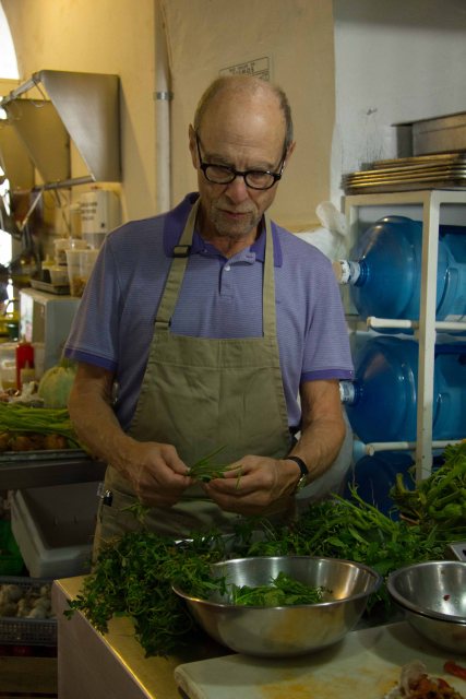 Henry cleans and preps the greens for the soup.