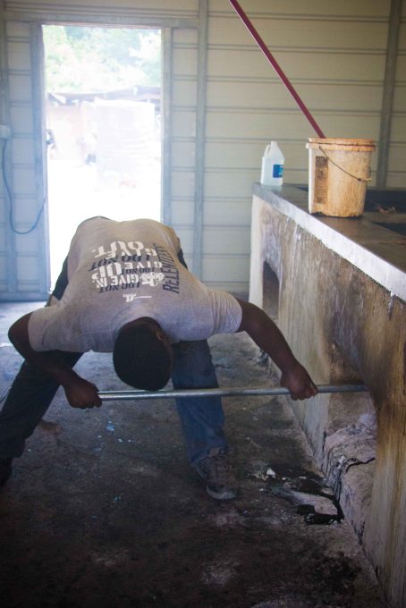 Coals are carefully placed in the pit. Wan says his method is to put the coals in the 4 corners and a line down the middle. 