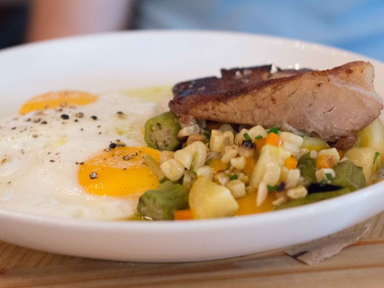 Braised pork belly with  Braised pork belly with stewed corn & charred okra, cherry tomatoes, polenta, sunnyside farm eggs, chili oil