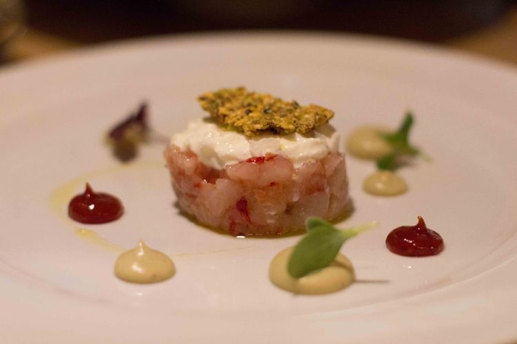 Red prawn tartare, burrata cheese, smoked eggplant cream, candied tomatoes with mustard and an “ugly but good” pistaccio cookie