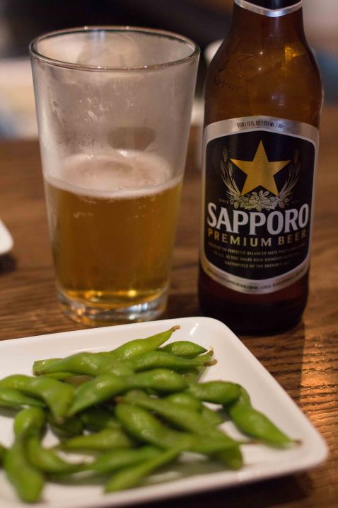 Edamame with a small Sapporo beer and a big cup